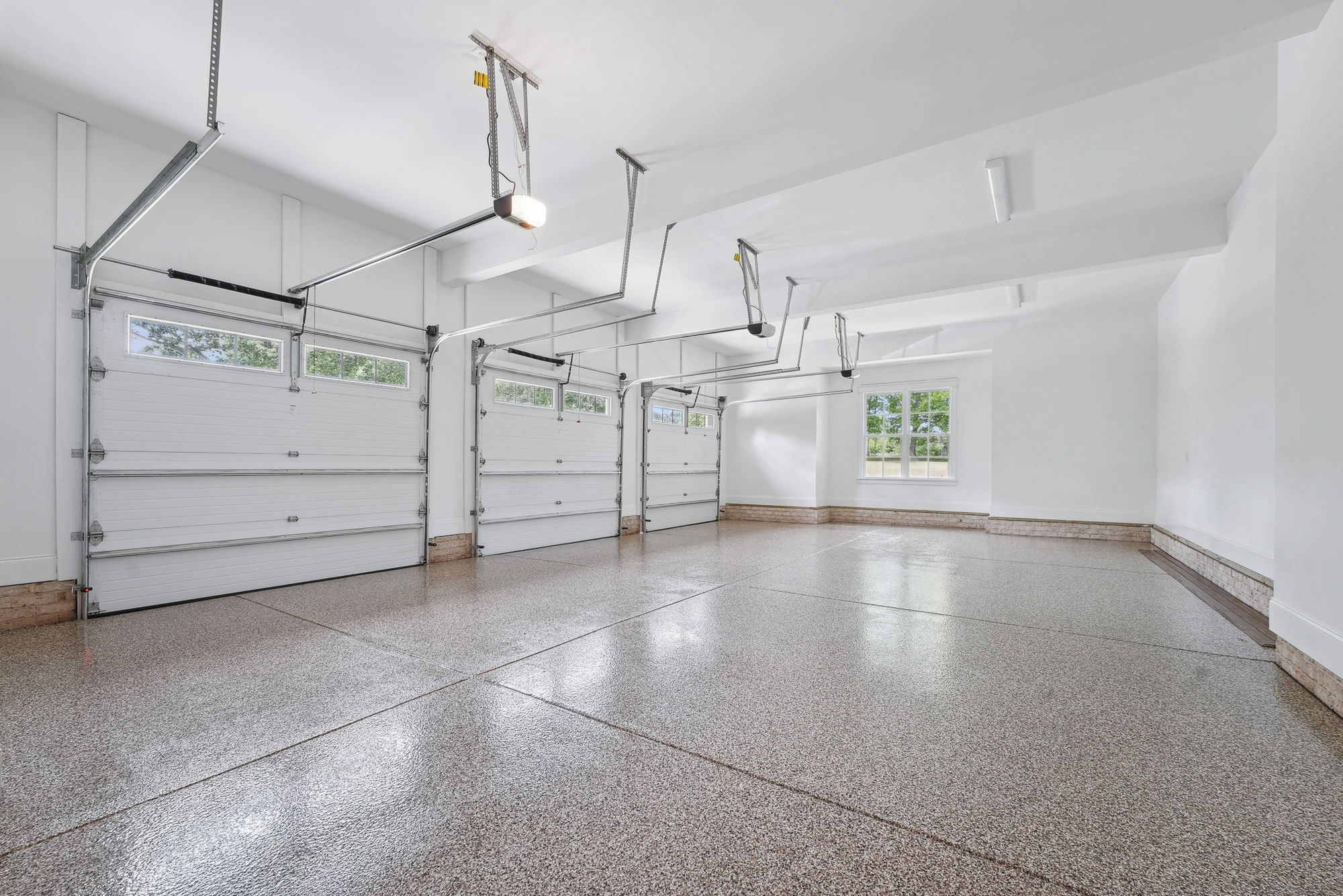Oversized garage interior with finished floors in Holly Springs home