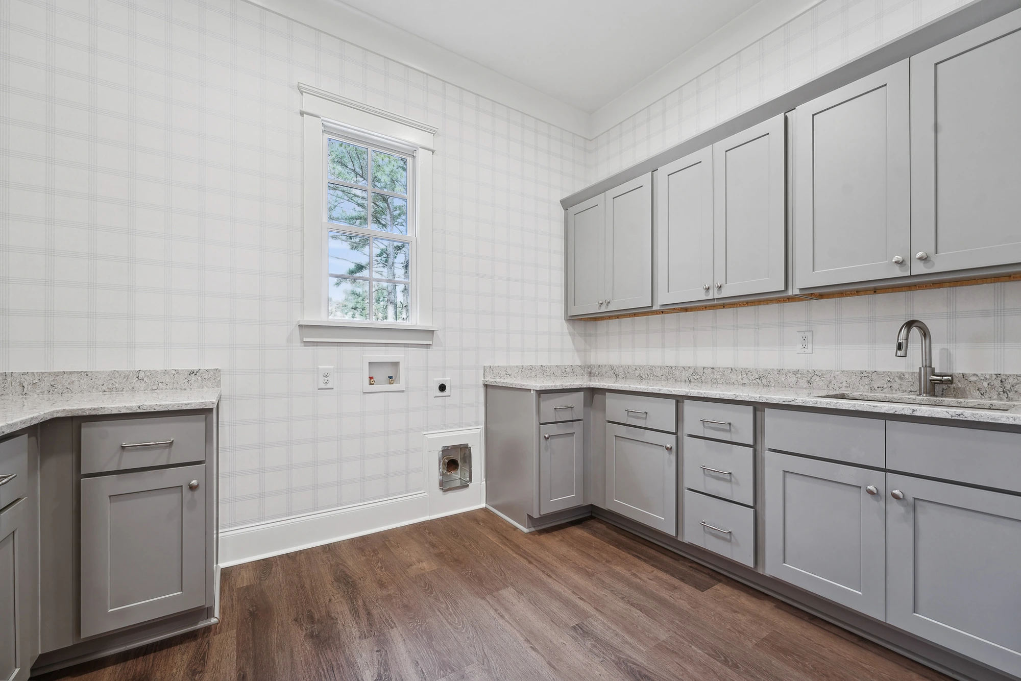Laundry room with custom cabinetry in Holly Springs custom build