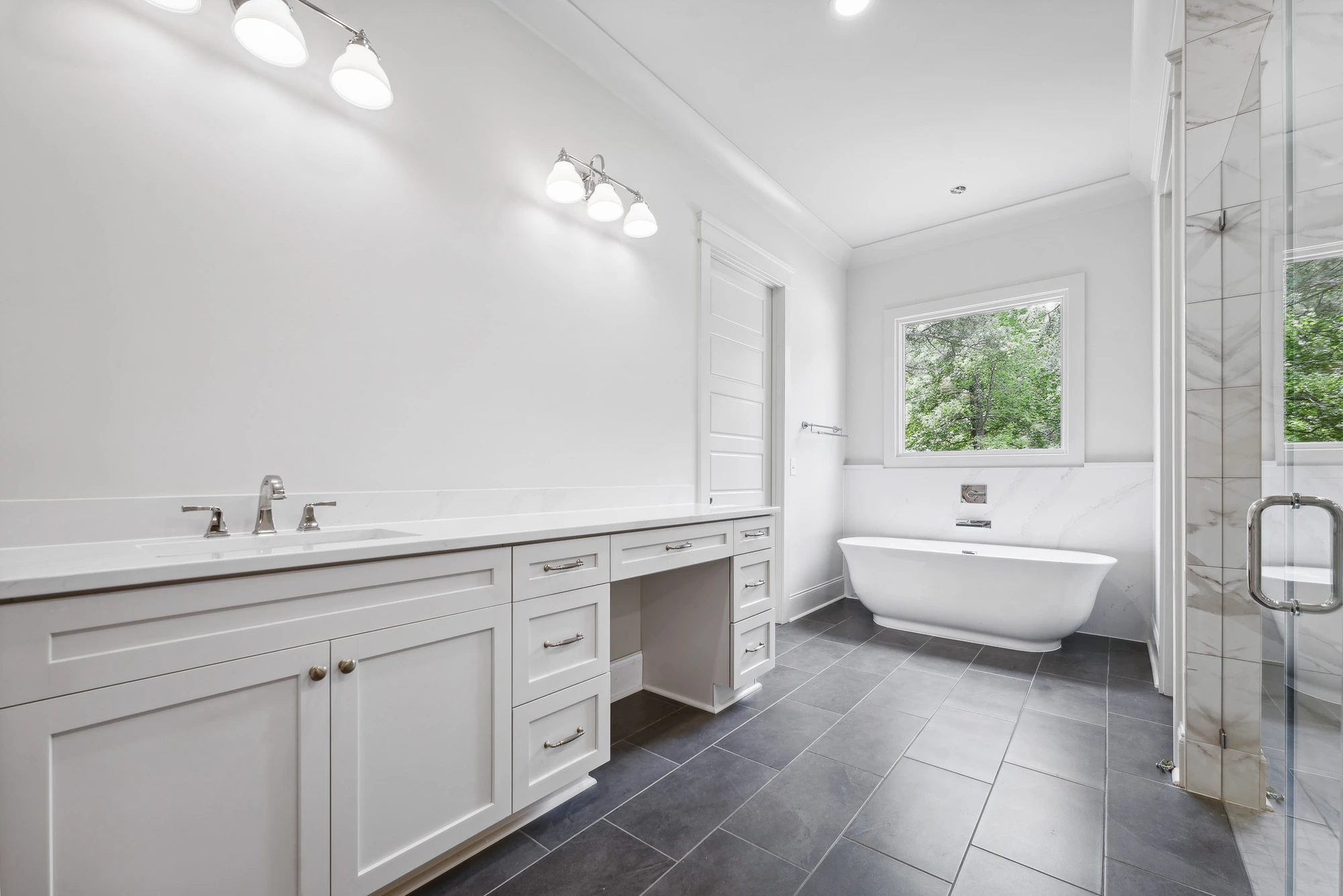Double vanity bathroom with freestanding tub in Holly Springs custom home